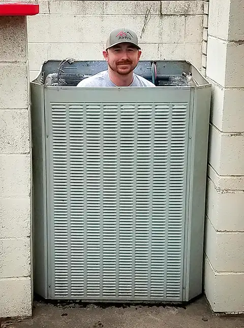 Shane really gets into his work when repairing an AC unit