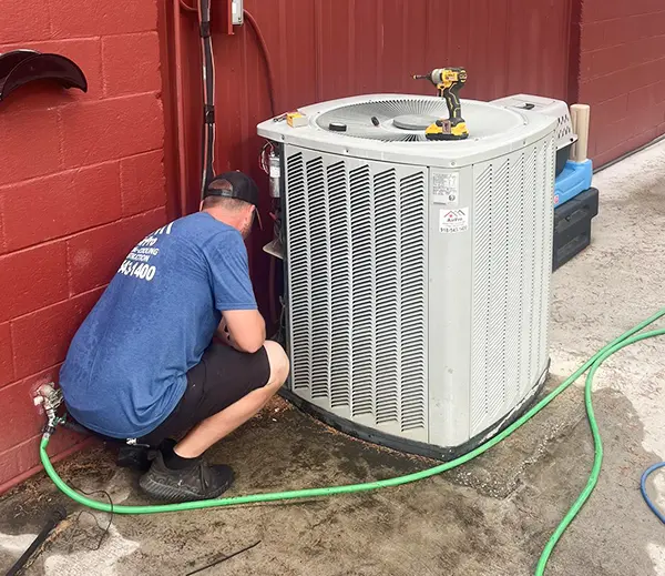Air Pro Conducting A Cleaning Of A Unit